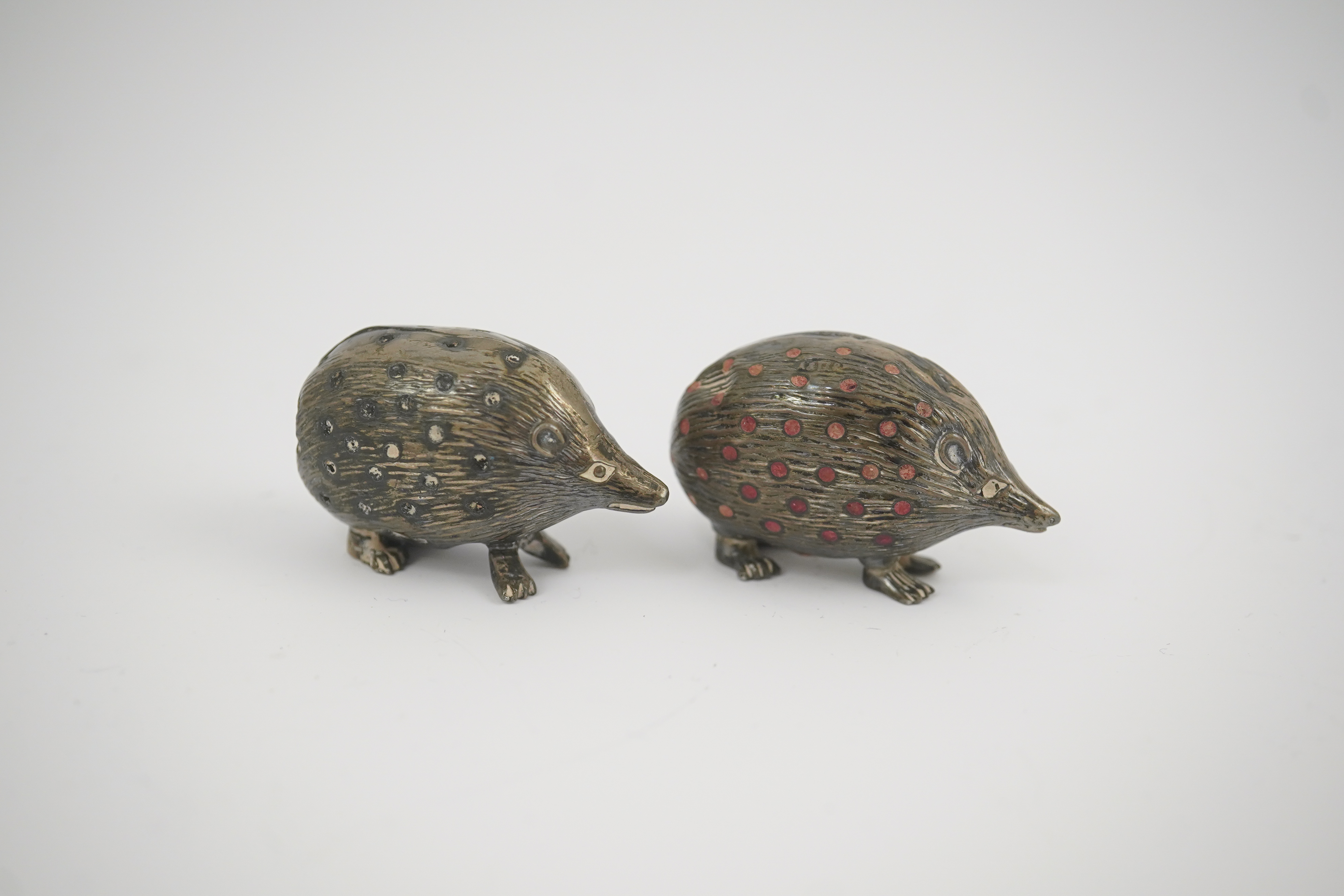 Two Edwardian silver novelty pin cushions, modelled as porcupines